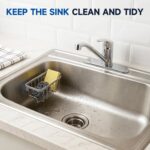 Silver rustproof aluminum sink caddy with two side hooks, holding a sponge and a brush, attached to a stainless steel sink.