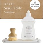 Sandstone Dorai Home Stone Sink Caddy with a dish soap bottle and brush, showing its quick-dry surface.