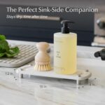 Sandstone Dorai Home Stone Sink Caddy with a dish soap bottle and brush, showing its quick-dry surface.