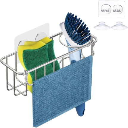 Silver KESOL stainless steel sink caddy holding two yellow sponges, a dish brush, and a folded dishcloth inside a kitchen sin