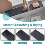 Dark gray diatomite stone faucet mat with a rectangular shape, placed around a kitchen sink faucet with items on it.