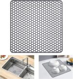 A gray Myirxcv 13.58 inch square silicone sink protector mat with raised nodules, shown unfolded in a kitchen sink.