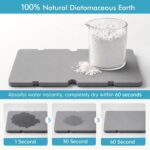 Black sponge holder for kitchen sink with a white drying stone and two removable cups, holding sponges and brushes.