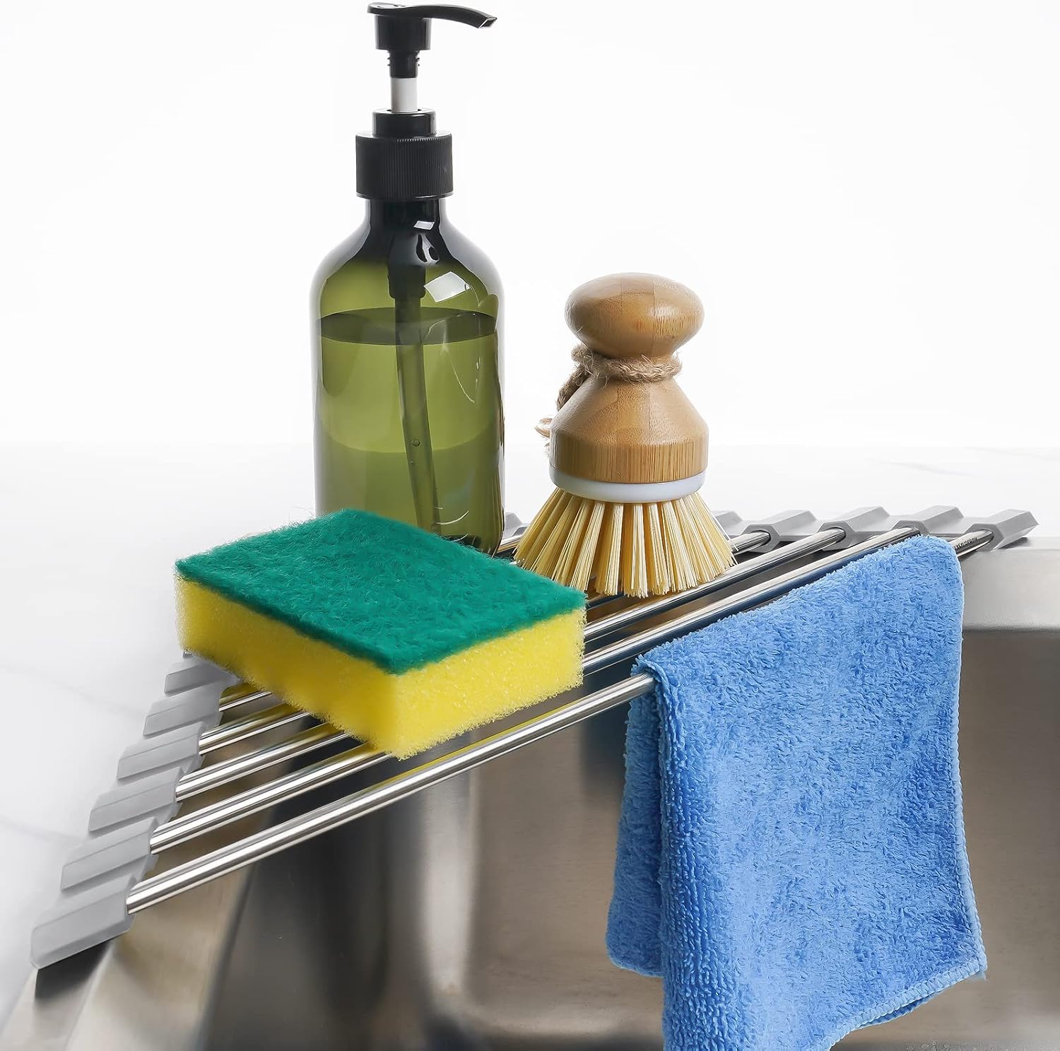 tomorotec-gray-triangle-roll-up-dish-drying-rack-for-sink-corner-1-count-01 Gray Tomorotec triangle roll-up dish drying rack extended over a sink corner with dishes and sponges on it.